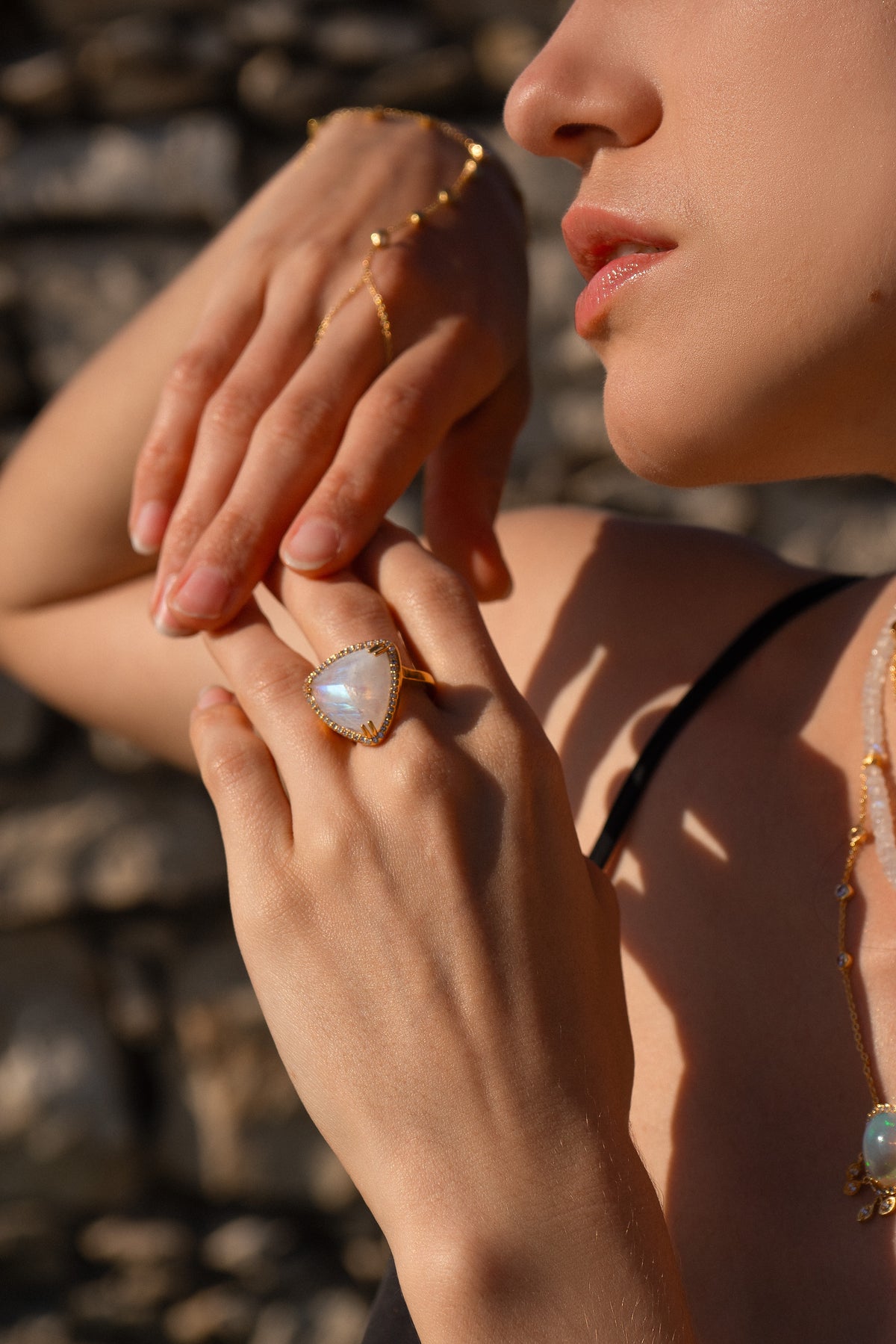 ASSYA sculptural gold and gemstone rings worn in warm evening light