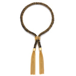 A black and gold 18 ct gold vermeil tassel bracelet with a woven design and gold vermeil chain. With adjustable closure