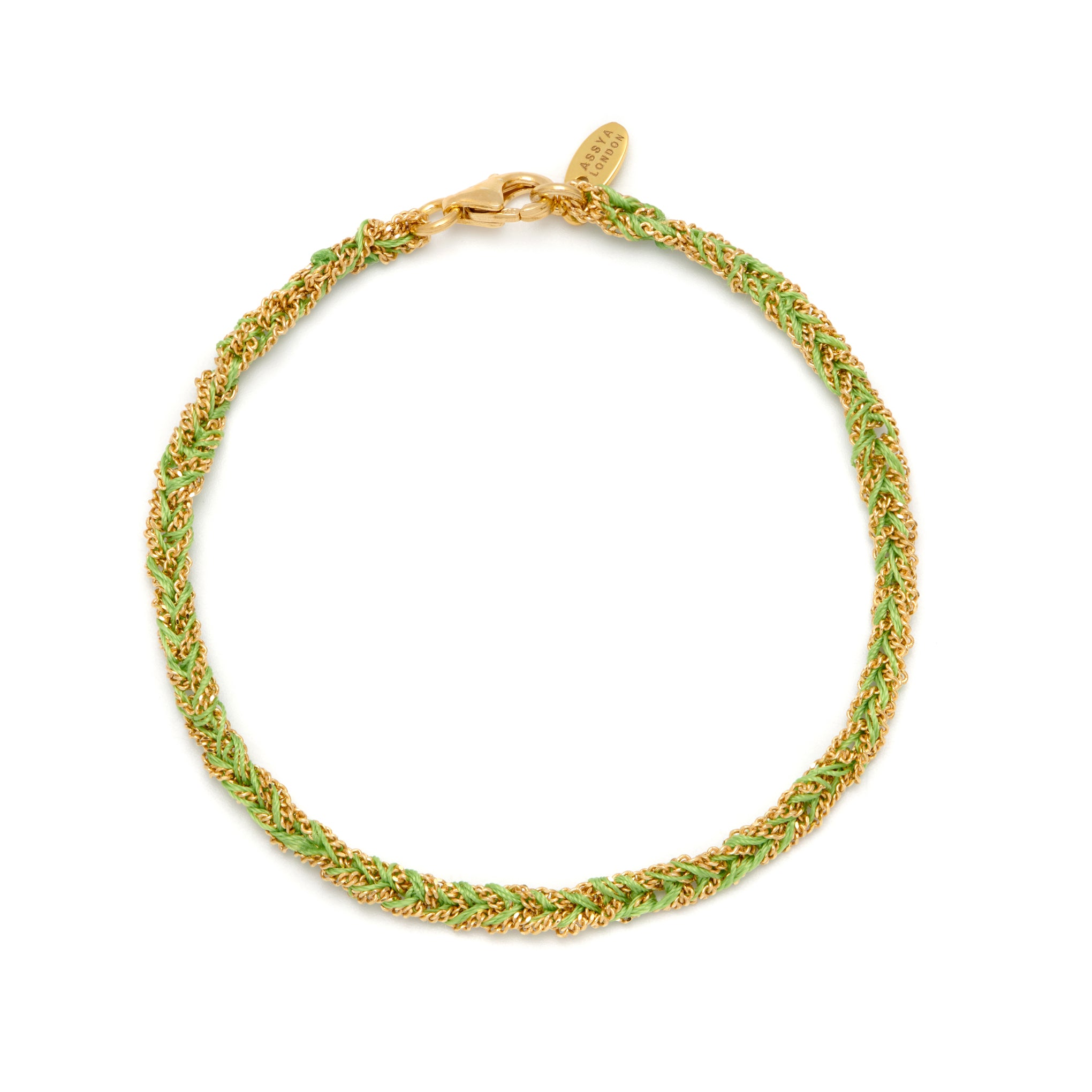 A gold and lime green friendship bracelet with a lobster clasp closure. 18ct gold vermeil plated sterling silver with green silk threads.