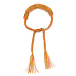 A rainbow, orange, pink, gold and green multicolored silk bracelet with 18ct gold plated silver chain and braided ties, ending with a fun tassel.