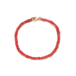 A 18ct plated rose gold and red silk friendship bracelet with a lobster clasp closure, hand woven using a Florentine technique.