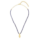 An 18ct gold plated vermeil on sterling silver necklace with blue Iolite beads and a white Zircon Hamsa charm with a gold and Iolite chain.