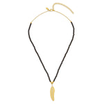 A black spinel feather necklace with 18ct gold plating vermeil and white zircon pave on a sterling silver chain.