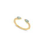 A 18ct gold plated vermeil open band ring with a central blue topaz and two smaller white zircons set in the band.