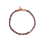 A hand-woven friendship bracelet with a combination of rose gold and purple elements, featuring a lobster clasp closure.