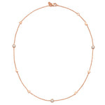 A 18ct plated rose gold vermeil necklace with natural white Zircon studs featuring Moon and Star motifs.