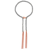 A sterling silver bracelet with 18ct rose gold accents and grey silk and rose gold tassels.