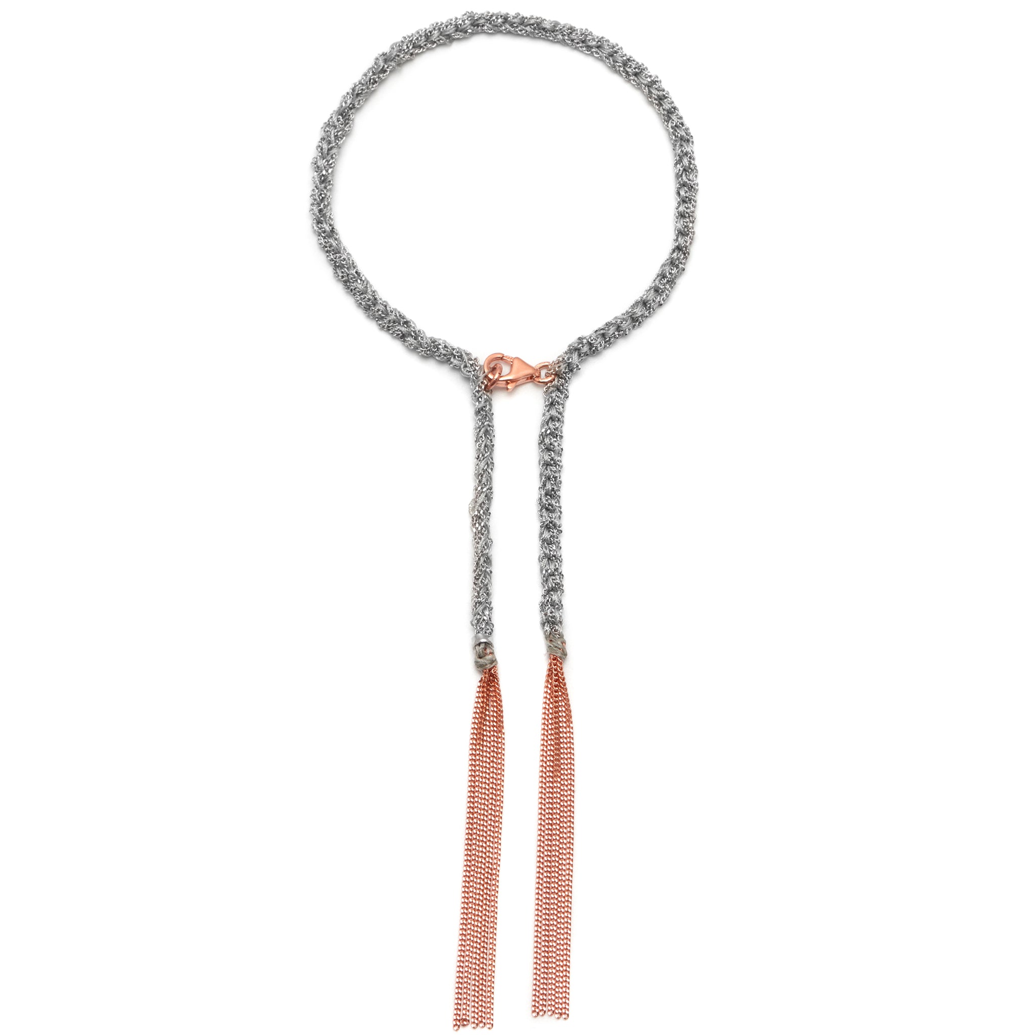 A sterling silver bracelet with 18ct rose gold accents and grey silk and rose gold tassels.