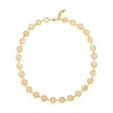 A necklace with round white moonstone gemstones, strung together with gold vermeil metal rings,