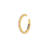 A gold-plated sterling silver ear cuff featuring tanzanite stones, with a fastening mechanism at the back.