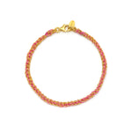 A 18ct gold and pink friendship bracelet with a lobster clasp closure, hand woven with silk thread and metal chains.