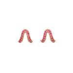 A pair of rose gold stud earrings with ruby pave accents