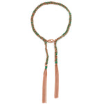 A woven emerald green and rose gold tassel bracelet with a lobster clasp closure.