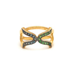 An 18ct gold vermeil ring with a black rhodium setting, featuring a cross design with multicolored gemstones including blue topaz, tsavorite