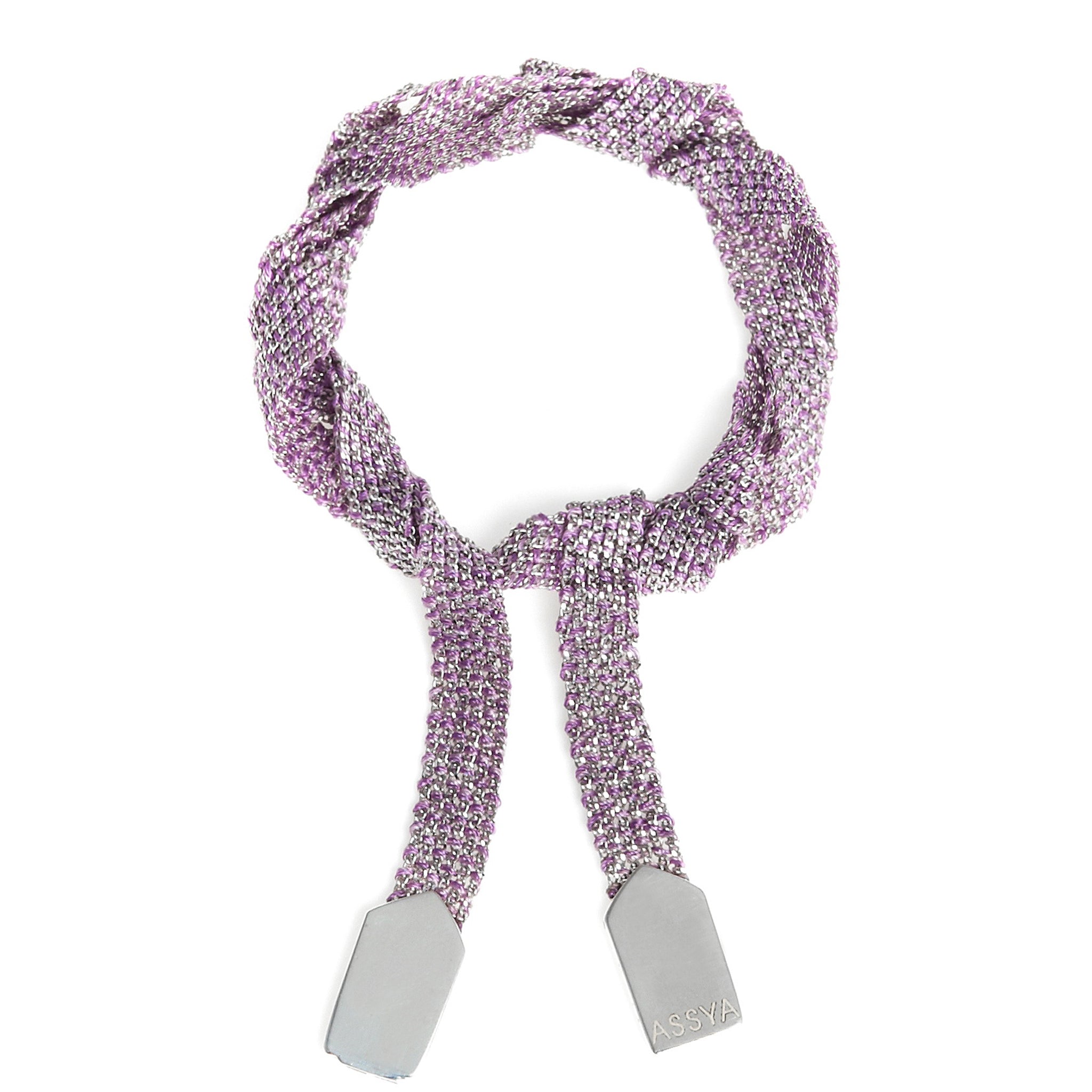 A silver and purple silk wrap bracelet tied in a knot
