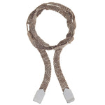 A silver and brown silk bracelet wrapped twice around a wrist and tied in a knot.