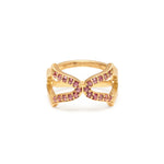 An 18ct gold vermeil ring with pink tourmaline stones set in an open-band design.