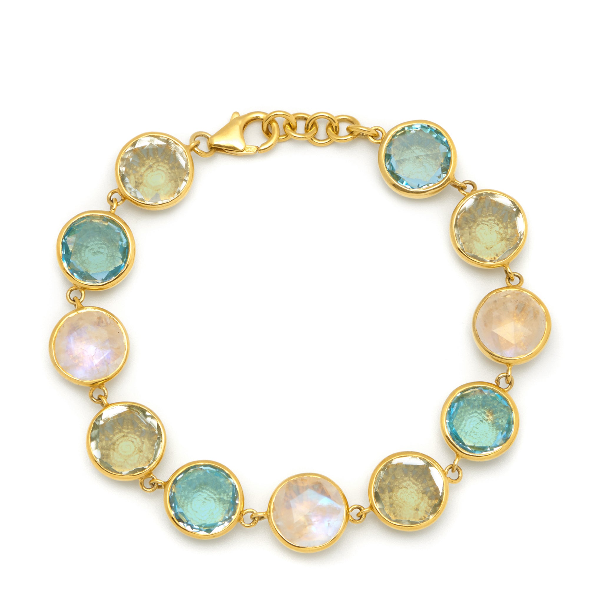 A gold-colored bracelet with faceted gemstones, featuring moonstone, blue topaz, and green amethyst, on a gold vermeil background.