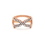 An 18ct rose gold vermeil ring with a black rhodium setting, featuring a cross design with white diamonds