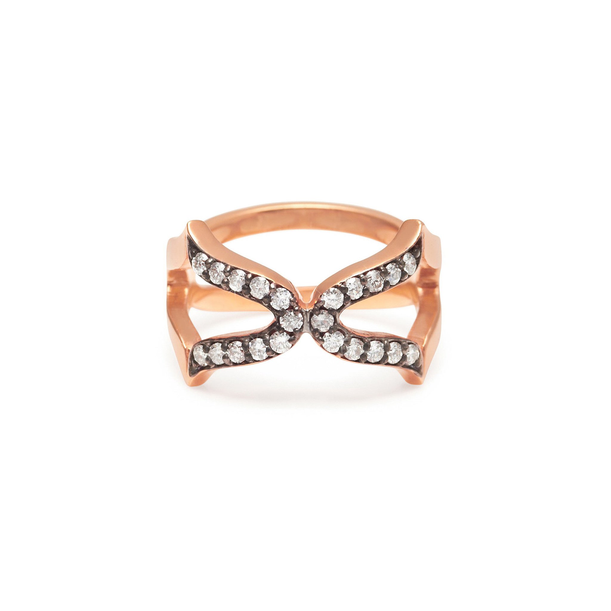 An 18ct rose gold vermeil ring with a black rhodium setting, featuring a cross design with white diamonds