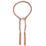 A Rose Gold and Light Grey tassel bracelet with a woven pattern and a lobster clasp closure.