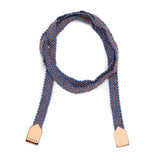 A bracelet with a combination of rose gold and blue silk, featuring a knotted design and rose gold plating.