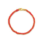 A 18ct gold vermeil chain and red silk woven friendship bracelet with a lobster clasp closure.