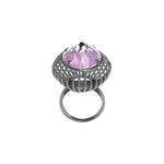 A Cocktail Ring with a purple amethyst gemstone set in a black rhodium cage on a sterling silver base, with a textured silver band.