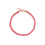 A hand-woven friendship bracelet in pink and 18ct rose gold colors, featuring silk thread and a gold vermeil chain.