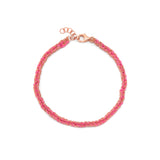 A hand-woven friendship bracelet in pink and 18ct rose gold colors, featuring silk thread and a gold vermeil chain.