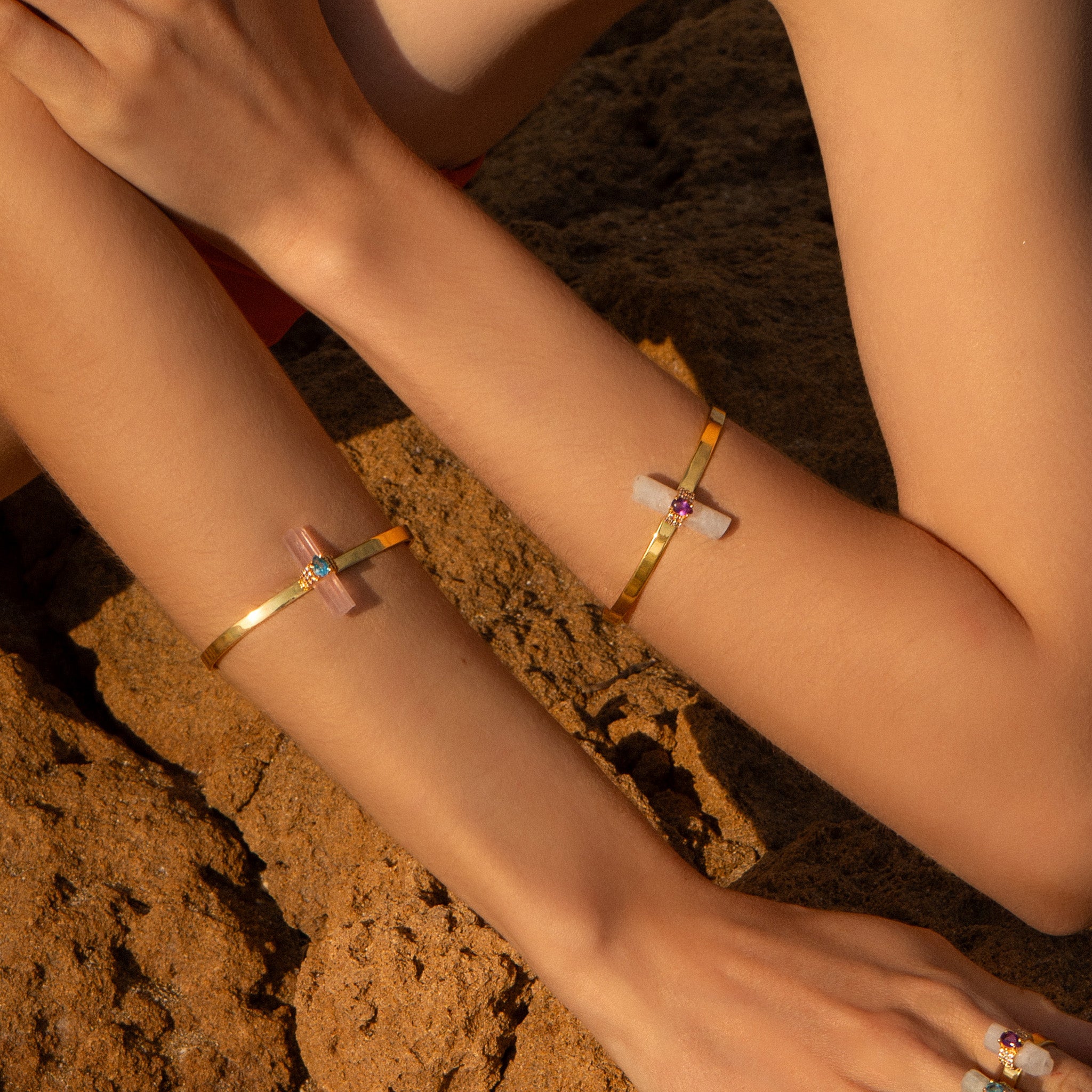 Model wearing the ASSYA rose quartz astra cuff and the Assya moonstone astra cuff